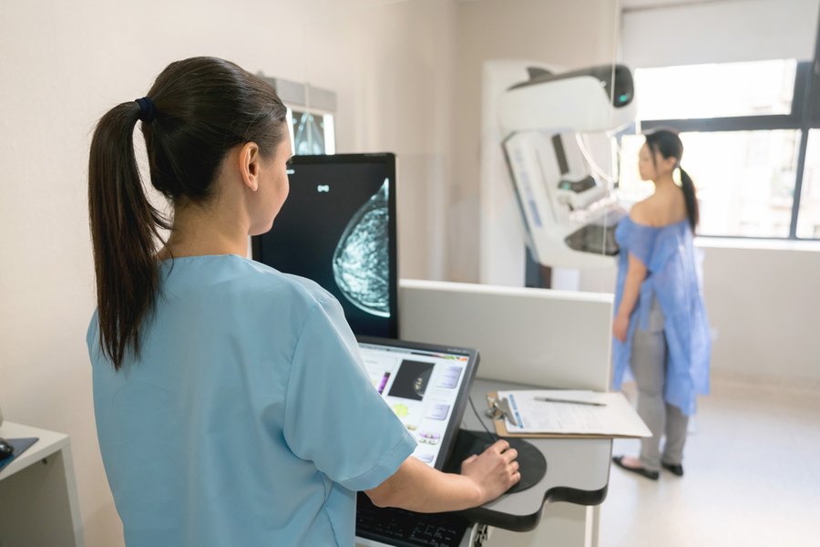 a doctor performing a mammogram