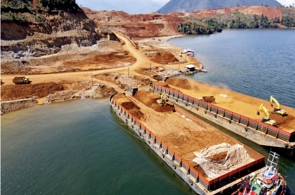 an overhead view of a mine and barges on a river